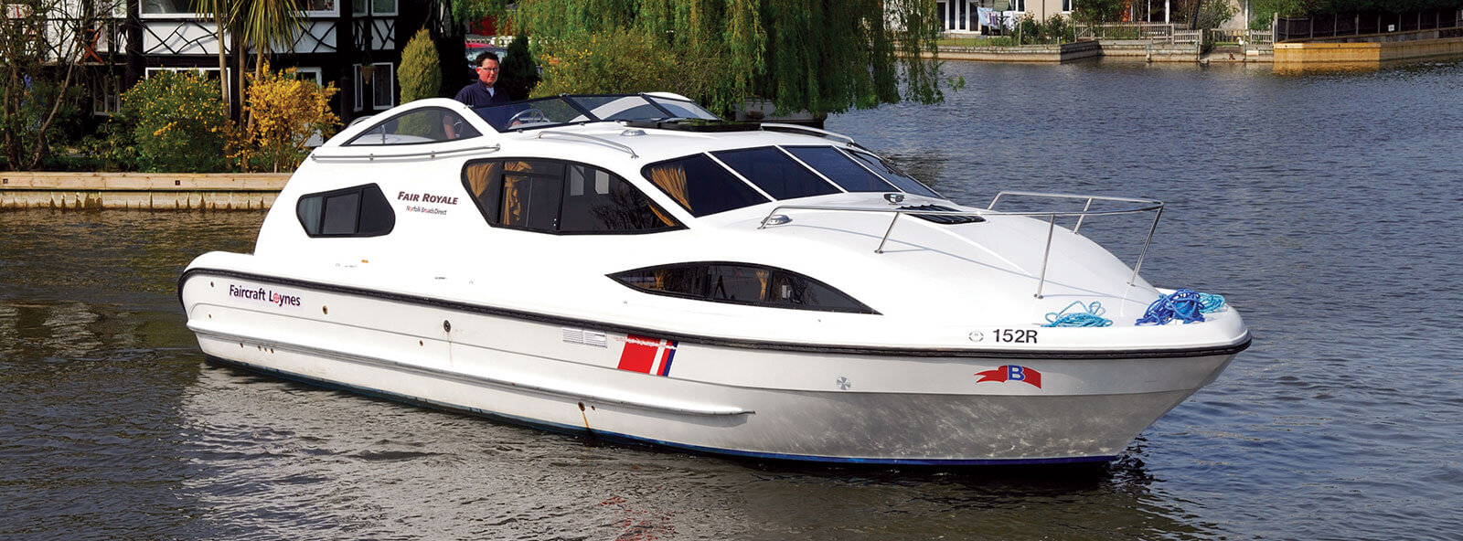 A man cruising during a norfolk broads boat hire